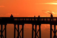 Casting a net at sunset