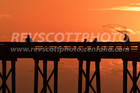 Casting a net at sunset