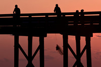Casting a net at sunset