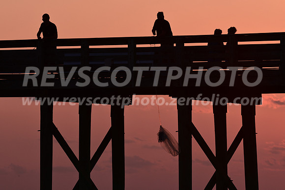 Casting a net at sunset